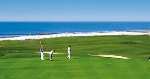 A golf course with a view of the ocean.