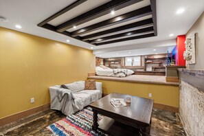 A cozy room with a sofa, a coffee table, and a colorful rug. - Luxury Point Loma Stay - Central, Coastal & Unique (San Diego)