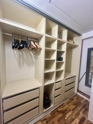 A walk-in closet with open shelving, hanging space, and drawers. - Spacious attic duplex in a heritage building in central Sarajevo (Sarajevo)