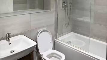 Combined shower/bathtub, deep-soaking bathtub, towels