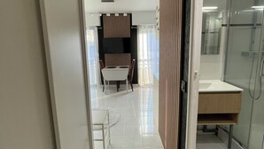 A modern hotel room with a bathroom, a dining area, and a living space. - GOLFE-JUAN (06220) WEEKLY STUDIO RENTAL – JULY & AUGUST (Vallauris)