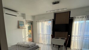 A modern bedroom with a bed, a desk, and a chair. - GOLFE-JUAN (06220) WEEKLY STUDIO RENTAL – JULY & AUGUST (Vallauris)