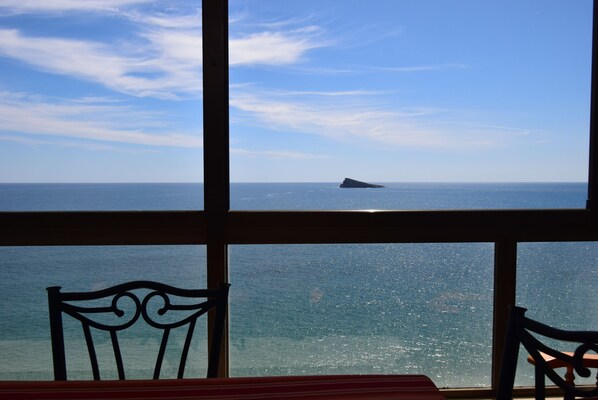 A view through a window with a table and two chairs, overlooking a calm sea and a distant rocky outcrop. - LOS Gemelos 15E in Benidorm (Benidorm)