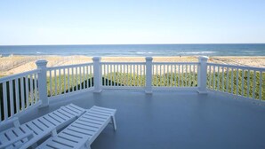 A balcony with white railings overlooking a beach. - Surf City Oceanfront Property (Surf City)