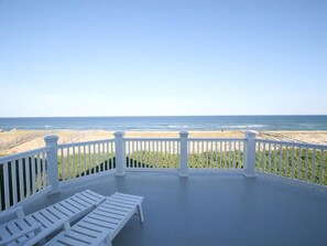 A balcony with white railings overlooking a beach. - Surf City Oceanfront Property (Surf City)