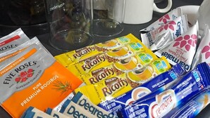 A variety of coffee products and tea bags on a table.