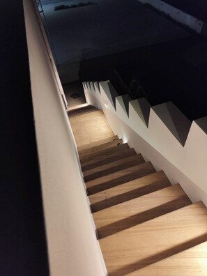 A staircase with wooden steps and white handrails. - Naxos Chora Next (Naxos)