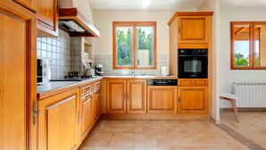 A kitchen with wooden cabinets, a stove, and a dishwasher.