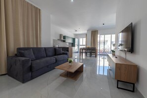 Ein modernes Wohnzimmer mit Sofa, Couchtisch und TV-Möbel.