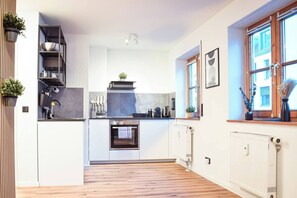 Eine moderne Küche mit eingebauten Geräten, einem Fenster mit Blick und einem Holzboden.
