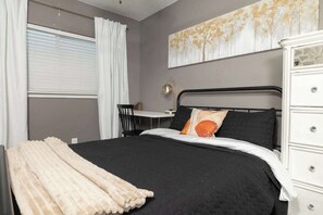 A bedroom with a bed, a desk, and a dresser. - Heated Pool • Game Rm • Theater • Firepit • Pets (San Antonio)