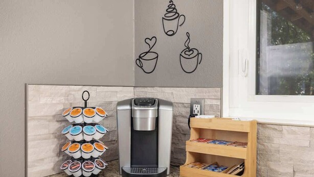 A coffee machine and a mug holder on a kitchen counter. - Heated Pool • Game Rm • Theater • Firepit • Pets (San Antonio)
