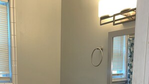 A bathroom with a toilet, sink, and mirror. - World Cup Gem 12 minutes from all attractions (Kansas City)