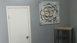 A bedroom with a bed, a door, a ceiling fan, a wall-mounted artwork, and a small table. - World Cup Gem 12 minutes from all attractions (Kansas City)
