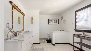 A bathroom with a vanity, a mirror, a sink, a toilet, and a window with blinds. - Comfortable 4BR•2 King Beds• Near Arbor Place Mall (Douglasville)
