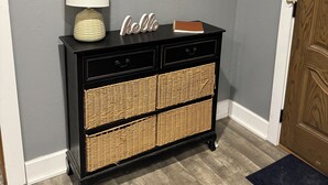 A black console with wicker baskets, a white lamp, and a mirror with a 'Hello' sign on a gray wall. - If you want quiet, peaceful, & a beautiful sunset, you’ll love House on the Hill (Media)