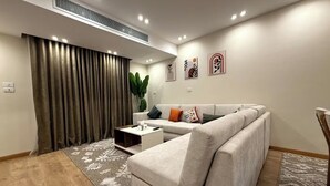 A modern living room with a sofa, coffee table, and a plant. - Diarna Lartin Residency 1 (Marsa Matrouh Governorate)