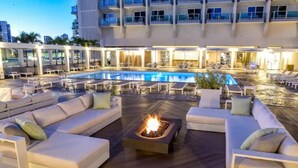 A rooftop pool area with lounge chairs and a fire pit. - Ala Moana 1 Bedroom · Ocean Views, Beach, Mall (Honolulu)