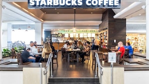 A Starbucks Coffee with indoor seating and a counter area. - Ala Moana 1 Bedroom · Ocean Views, Beach, Mall (Honolulu)