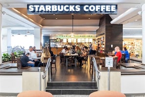 A Starbucks Coffee with indoor seating and a counter area.