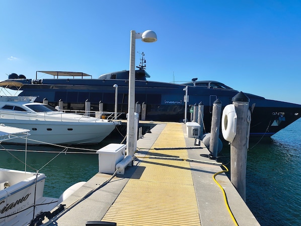 A dock with a yacht named 'Matrix' and another boat named 'Coco'.