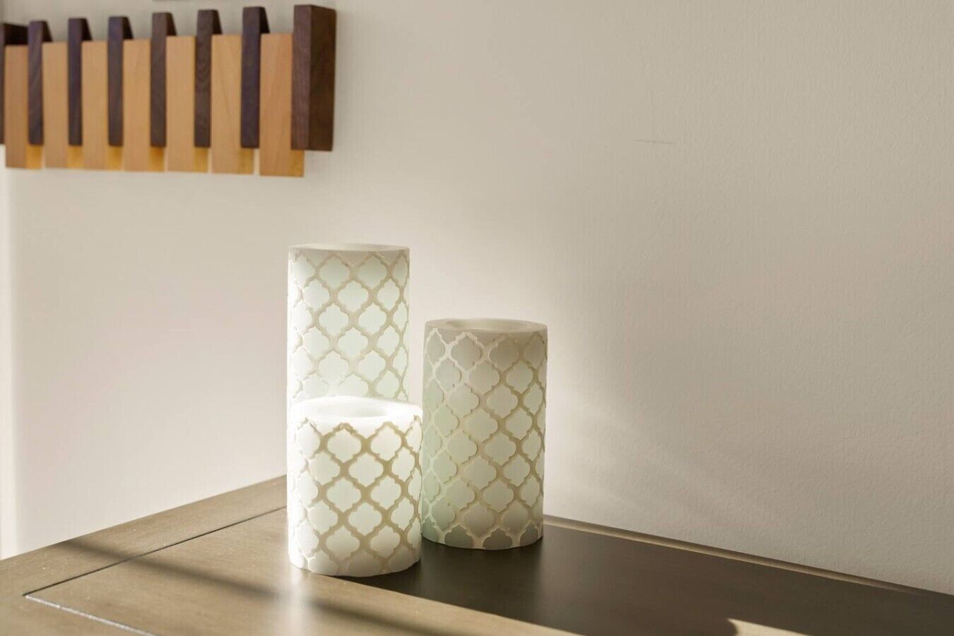 Two cylindrical objects with a geometric pattern on a flat surface.