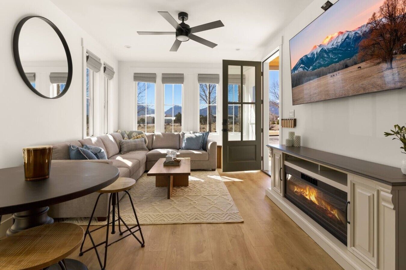 A modern living room with a sofa, coffee table, and fireplace.
