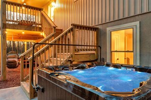 Ein Whirlpoolbereich mit Holzgeländern und einer Treppe, die zu einer erhöhten Terrasse führt.