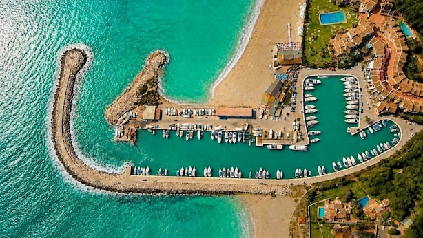 An aerial view of a coastal resort with a marina, beach, and pool area. - Casa de la Alegria, 3BD house near Cabopino Beach (Marbella)
