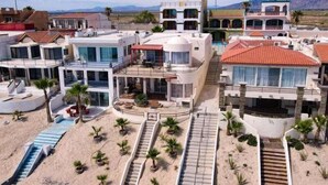 Et moderne resort med flere bygninger, en pool og et strandområde.