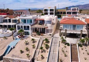 A modern resort with multiple buildings, a pool, and a beach area. - Casa Dos Pisos - Combined 2-Unit Beachfront House San Felipe Baja California (San Felipe)