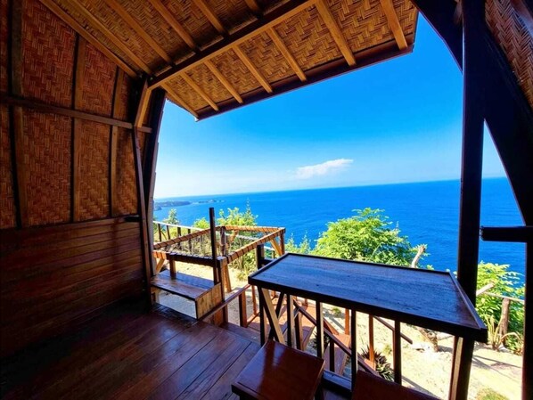 A wooden deck with a view of the ocean.