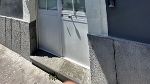 Un bâtiment doté d’une grande fenêtre, d’une porte et d’une petite fenêtre sur le côté.
