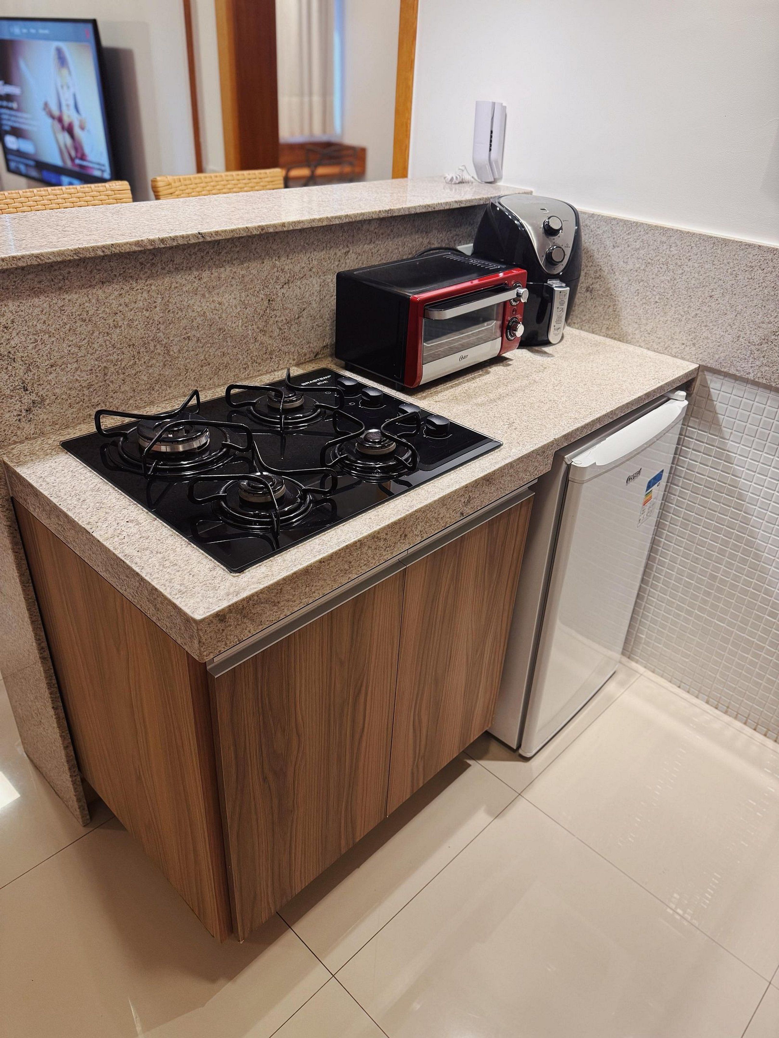 A kitchen with a gas stove, a toaster, and a dishwasher.
