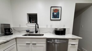 A modern kitchen with a stainless steel dishwasher, a coffee maker, and a toaster. - Fully Renovated 4-Bedroom, 3-Bath Home in the Heart of Austin's Attractions (Austin)