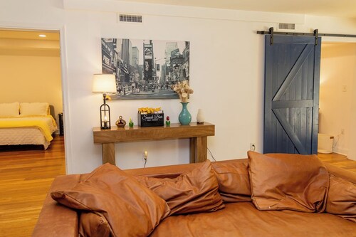 The New Amsterdam Nook: European-inspired guest suite in Mechanicsville. Features 2 bedrooms, 1 spa-like bath, full kitchen, indoor fireplace, dedicated workspace. Enjoy a large yard with pool, hot tub, playground, and BBQ. Comfortably fits 4-6.