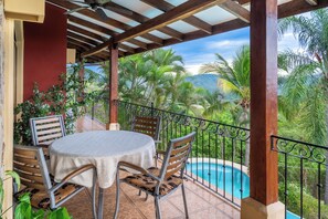 A covered patio with a pool, wooden chairs, and a table. - Ocean View Tropical Retreat w/ Private Saltwater Pool and Epic Sunset Views! (Potrero)