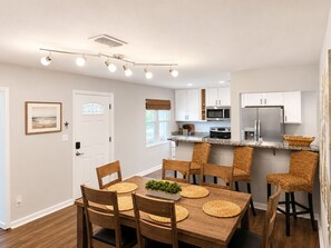 A modern kitchen with white cabinets, a stainless steel refrigerator, and a microwave. - Private Pool Near Okaloosa Island+Destin+Navarre. Sunny Days Beach Escape (Mary Esther)