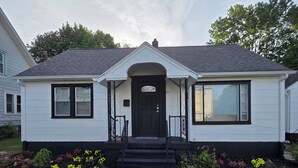 A single-story house with a front entrance, a small porch, and a paved driveway. - Alimot Spa House:Private INDOOR Hot Tub  Near SU & Downtown  Named for My Mother (Syracuse)