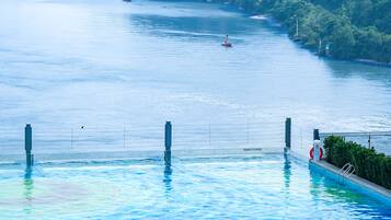 Outdoor pool, open 9:00 AM to 9:00 PM, pool umbrellas