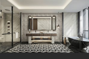 A modern bathroom with a marble vanity, a large mirror, a freestanding bathtub, and a geometric patterned floor.