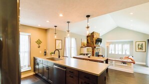A spacious kitchen with a large island, built-in appliances, and pendant lighting. - The Northport Sapling | In-Town Northport | Walk to Bay, Shops + Dining (Northport)