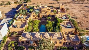 A large, multi-story building with a central courtyard, multiple balconies, and a swimming pool. - Riad Jnane Ines (Machraa El Ain)