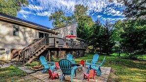 A house with a deck, outdoor seating, and a staircase leading to the upper level. - Dog-friendly Home With Free Wifi, Central AC, Firepit, & Furnished Deck (Mineral)
