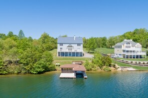 A lakeside property with a main house, a secondary house, and a docked boat. - Dog-friendly, Lakefront Home With Private Dock, 2 Kayaks, Decks & Game Room (Mineral)