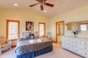 A bedroom with a bed, dresser, chair, and a ceiling fan. - Dog-friendly, Lakefront Vacation Home w/ a Boat House, Kayaks, & Paddleboards (Mineral)