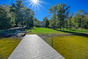 A wooden dock leading to a calm water body, surrounded by lush greenery and trees. - Lakefront Home With Private hot Tub, Wifi, fun rec Room, & Beach Area (Mineral)