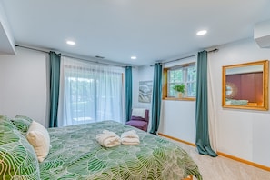 A bedroom with a bed, curtains, a chair, a mirror, and a window. - Lakefront Adventure House With Private Dock & Wifi - Dog-friendly (Bumpass)
