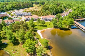 An aerial view of a residential area with houses, a dock, and a lake. - Three-story Lakefront Home w/ Covered Boat Slip, and Tennis/pickleball Access (Mineral)