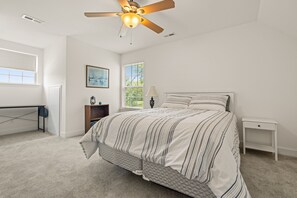A bedroom with a bed, a standing lamp, a ceiling fan, a window, and a desk. - Lakeview Escape Near Beach With Fenced dog Run, Porch & Dock With one Boat Slip (Louisa)